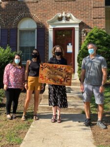 Pathway Homes employees hold a welcome mat